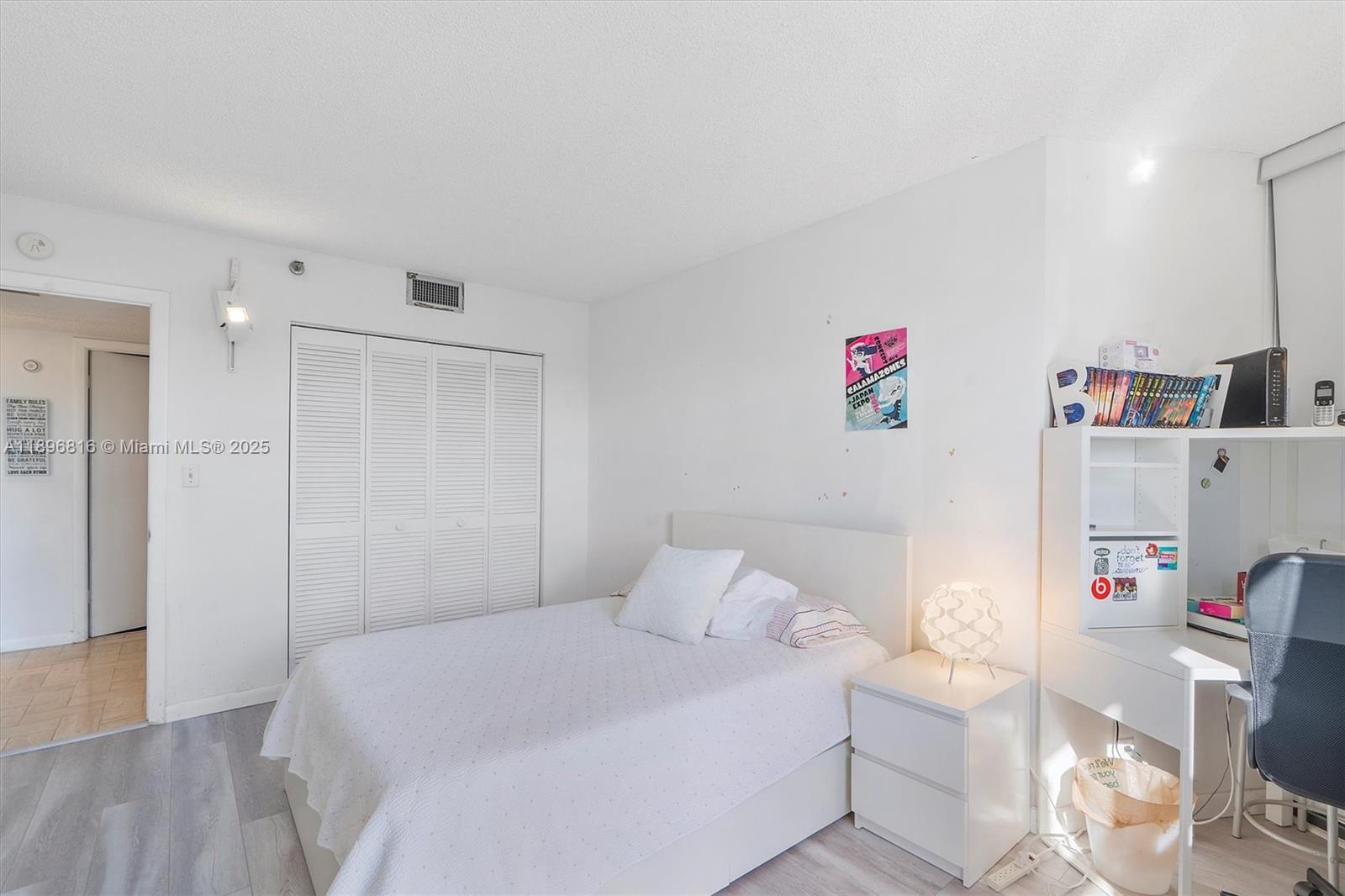 4000 Towerside Terrace, Unit 402 Miami, FL 33138 - Photo 26 of 54 a bedroom with a bed and a book shelf