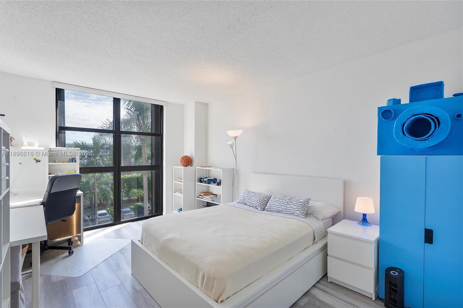 4000 Towerside Terrace, Unit 402 Miami, FL 33138 - Photo 27 of 54 a bedroom with a bed and a large window