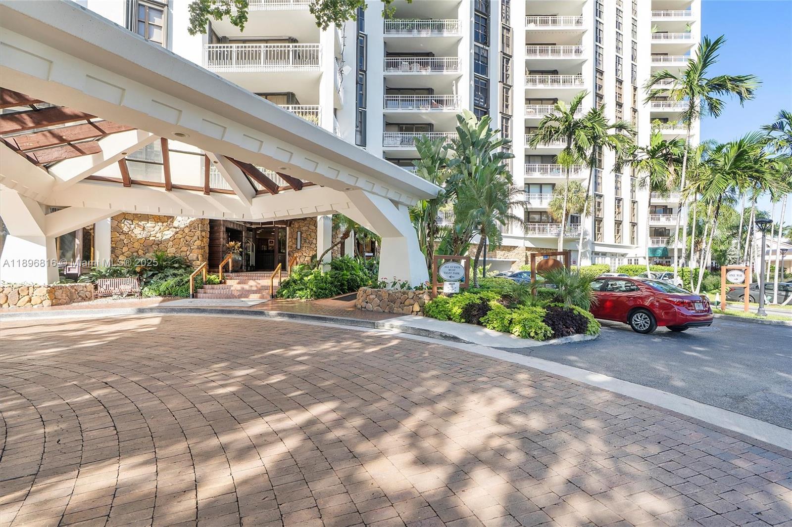 4000 Towerside Terrace, Unit 402 Miami, FL 33138 - Photo 3 of 54 a view of a cars park in front of a building