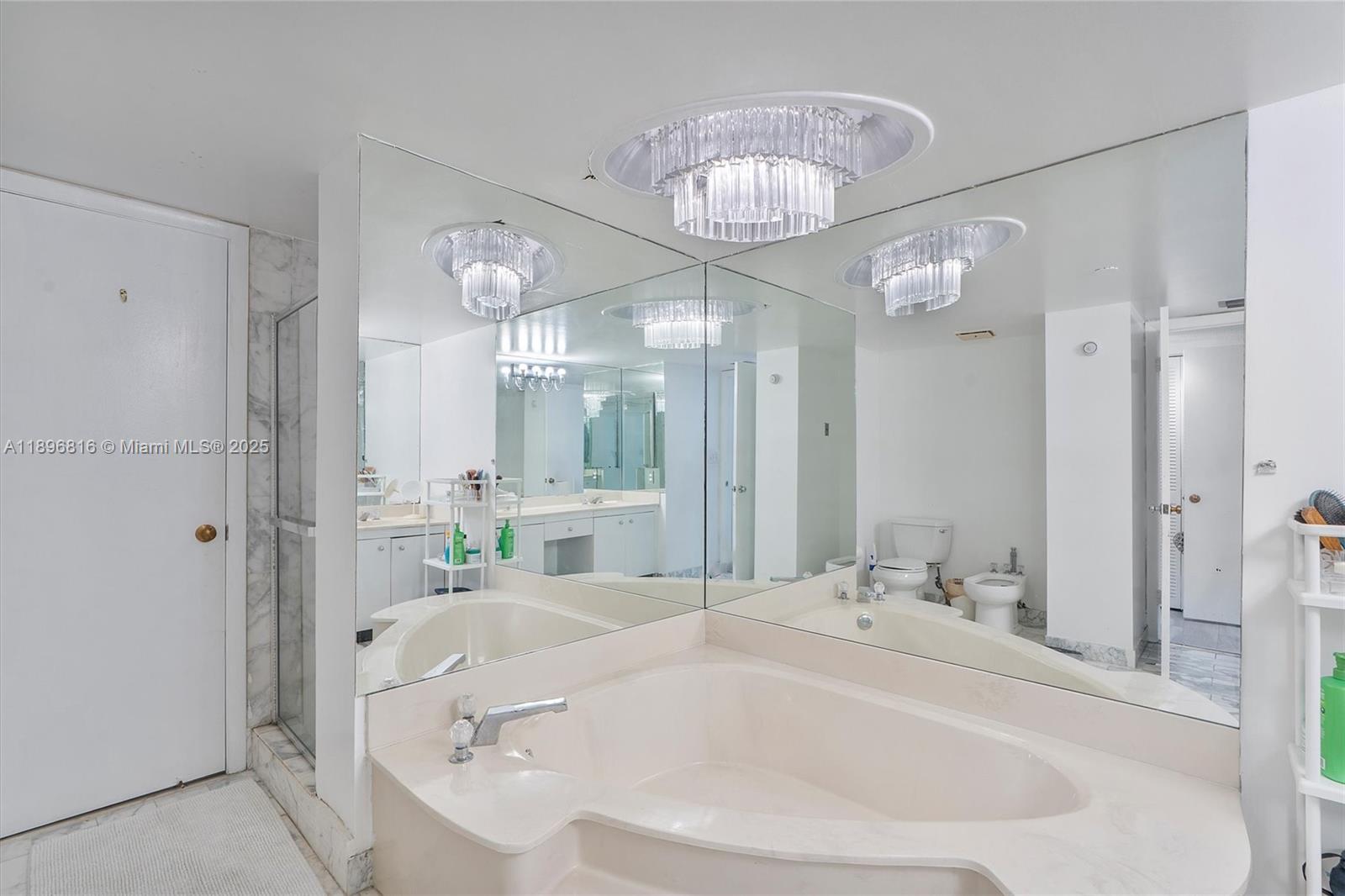 4000 Towerside Terrace, Unit 402 Miami, FL 33138 - Photo 31 of 54 a bathroom with a bathtub and a chandelier
