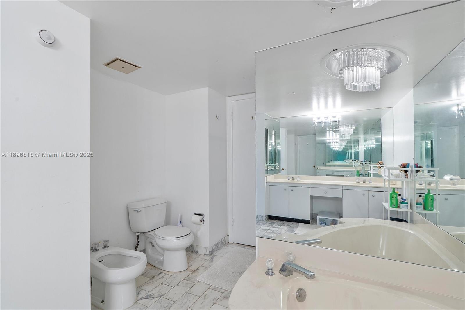 4000 Towerside Terrace, Unit 402 Miami, FL 33138 - Photo 32 of 54 a bathroom with a sink a toilet and a mirror