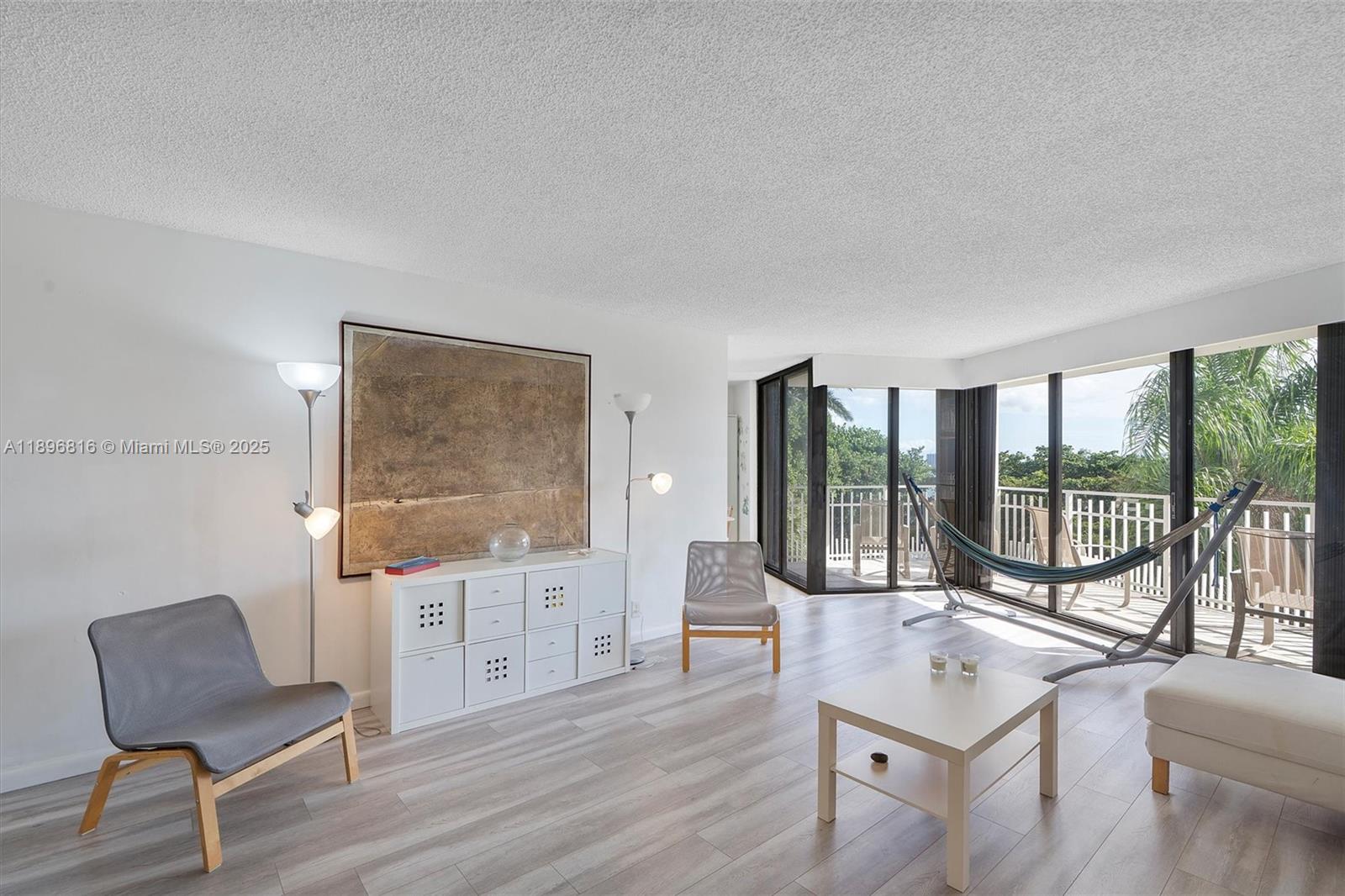 4000 Towerside Terrace, Unit 402 Miami, FL 33138 - Photo 4 of 54 a living room with furniture and a floor to ceiling window