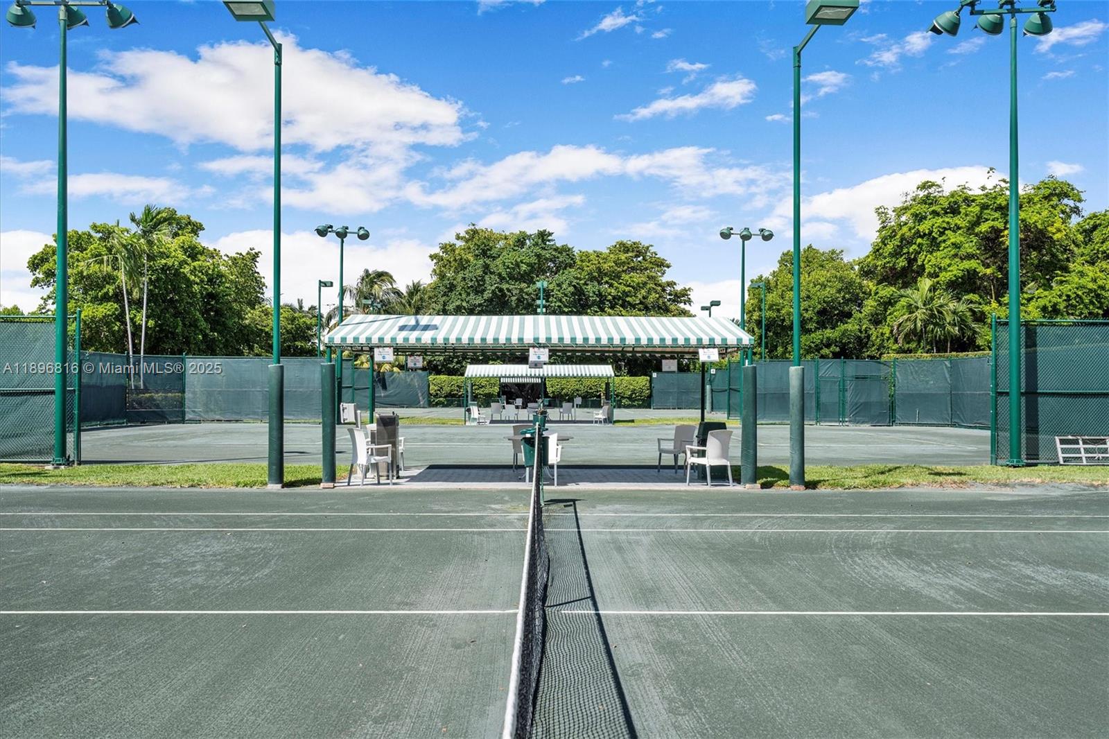4000 Towerside Terrace, Unit 402 Miami, FL 33138 - Photo 50 of 54 a view of a patio with a table and chairs