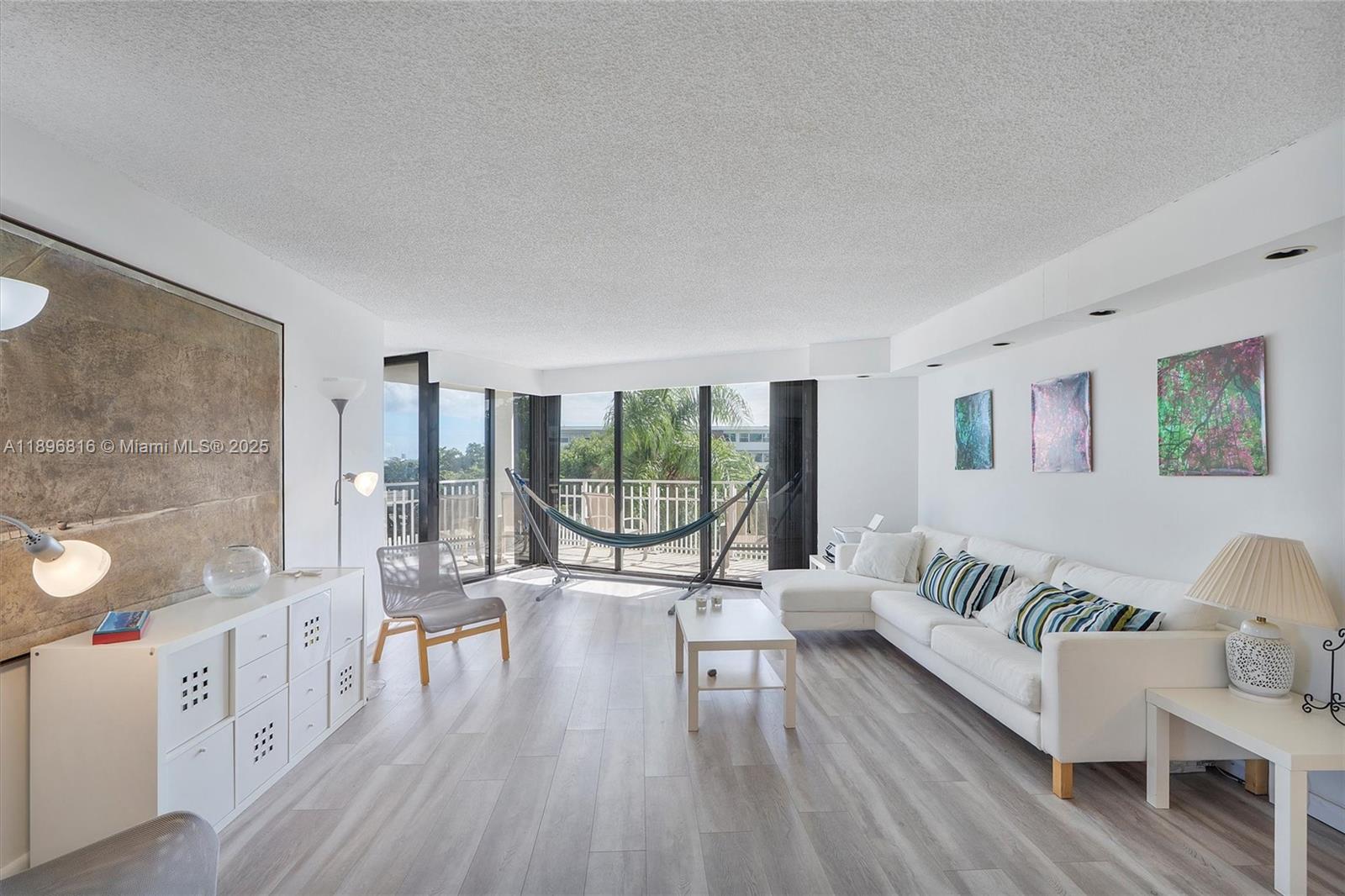 4000 Towerside Terrace, Unit 402 Miami, FL 33138 - Photo 5 of 54 a living room with furniture and a large window