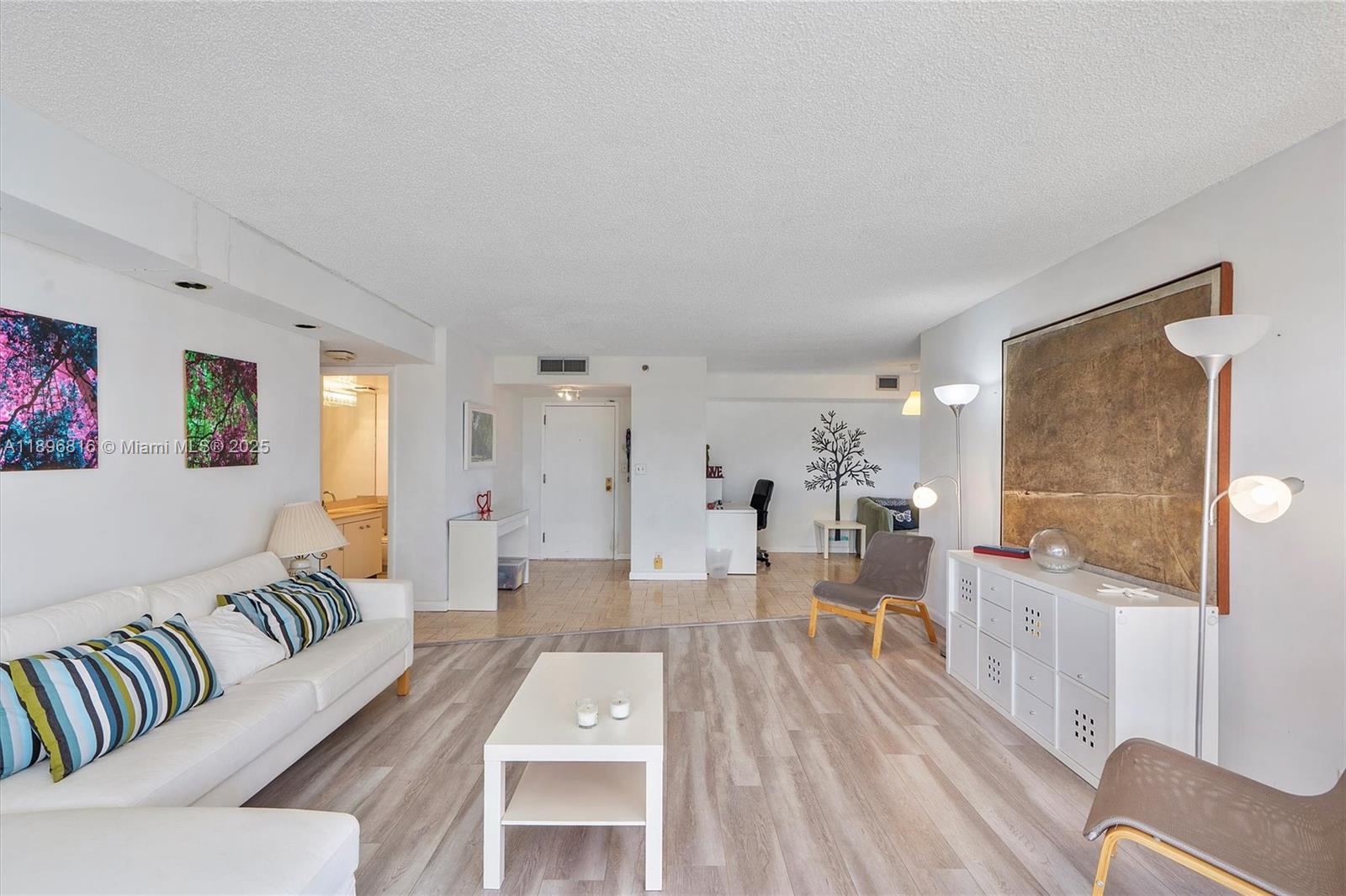 4000 Towerside Terrace, Unit 402 Miami, FL 33138 - Photo 9 of 54 a living room with furniture and wooden floor