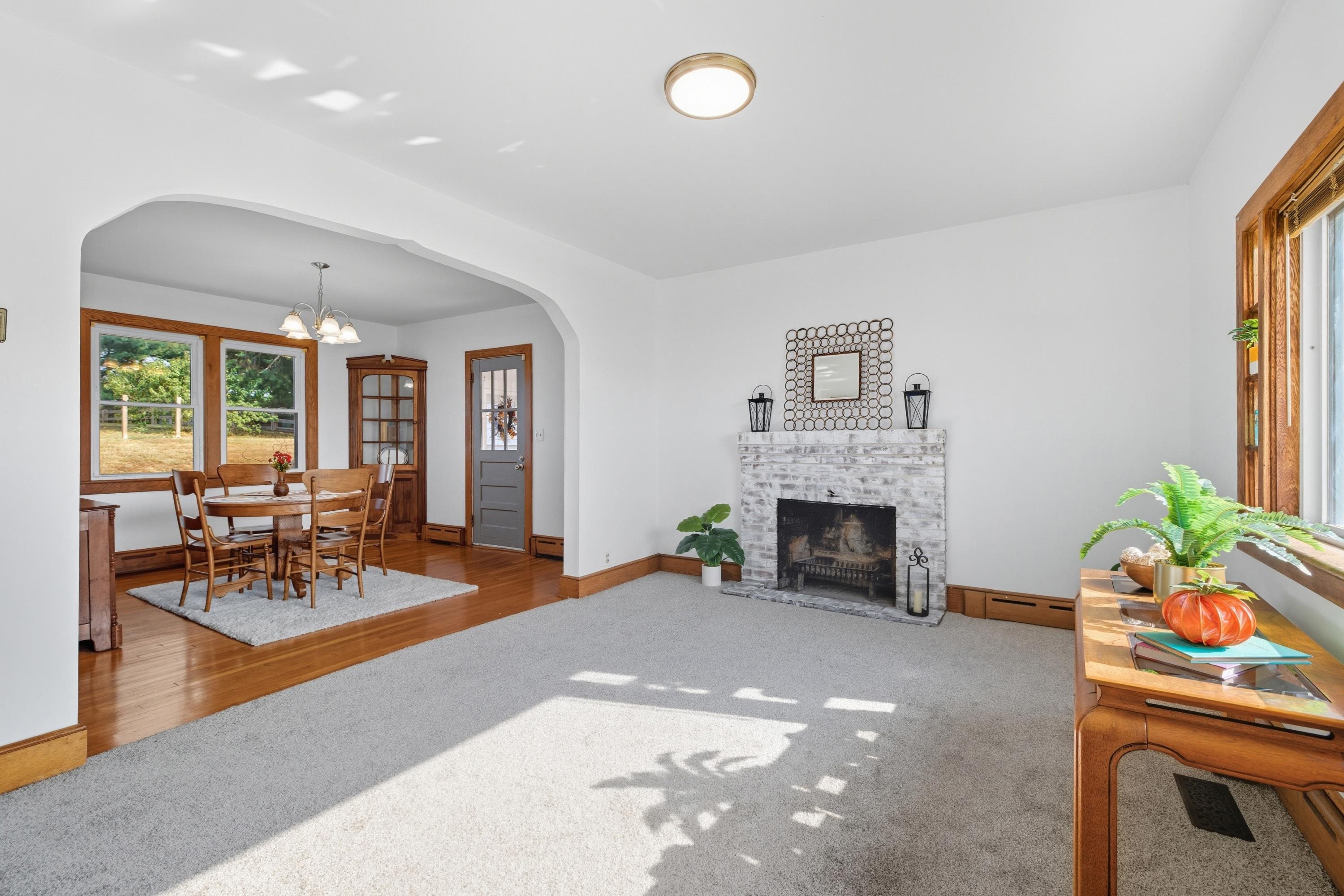 3138 Cross Keys Road Harrisonburg, VA 22801 - Photo 26 of 74 The living room space is located off the entrance to the home and near the steps leading to the upper level. This space features a fireplace, comfortable flooring, updated light fixture, and large windows allowing in an abundance of natural light!