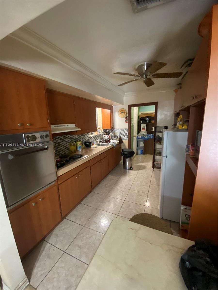 629 Southwest 4th Street Hallandale Beach, FL 33009 - Photo 4 of 4 a kitchen with refrigerator and window