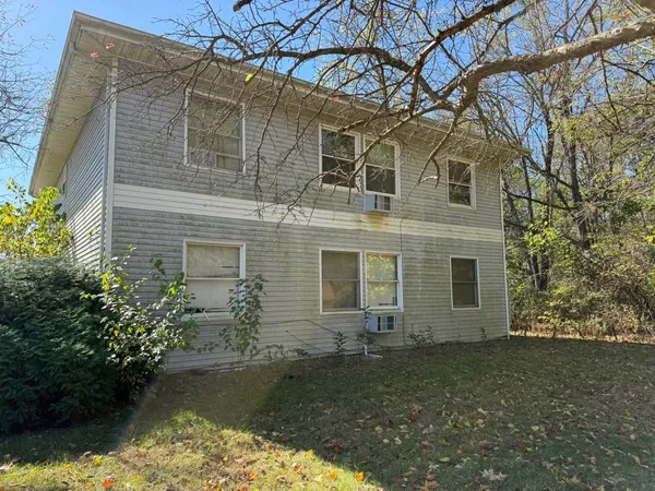 a backyard of a house with lots of green space and fountain