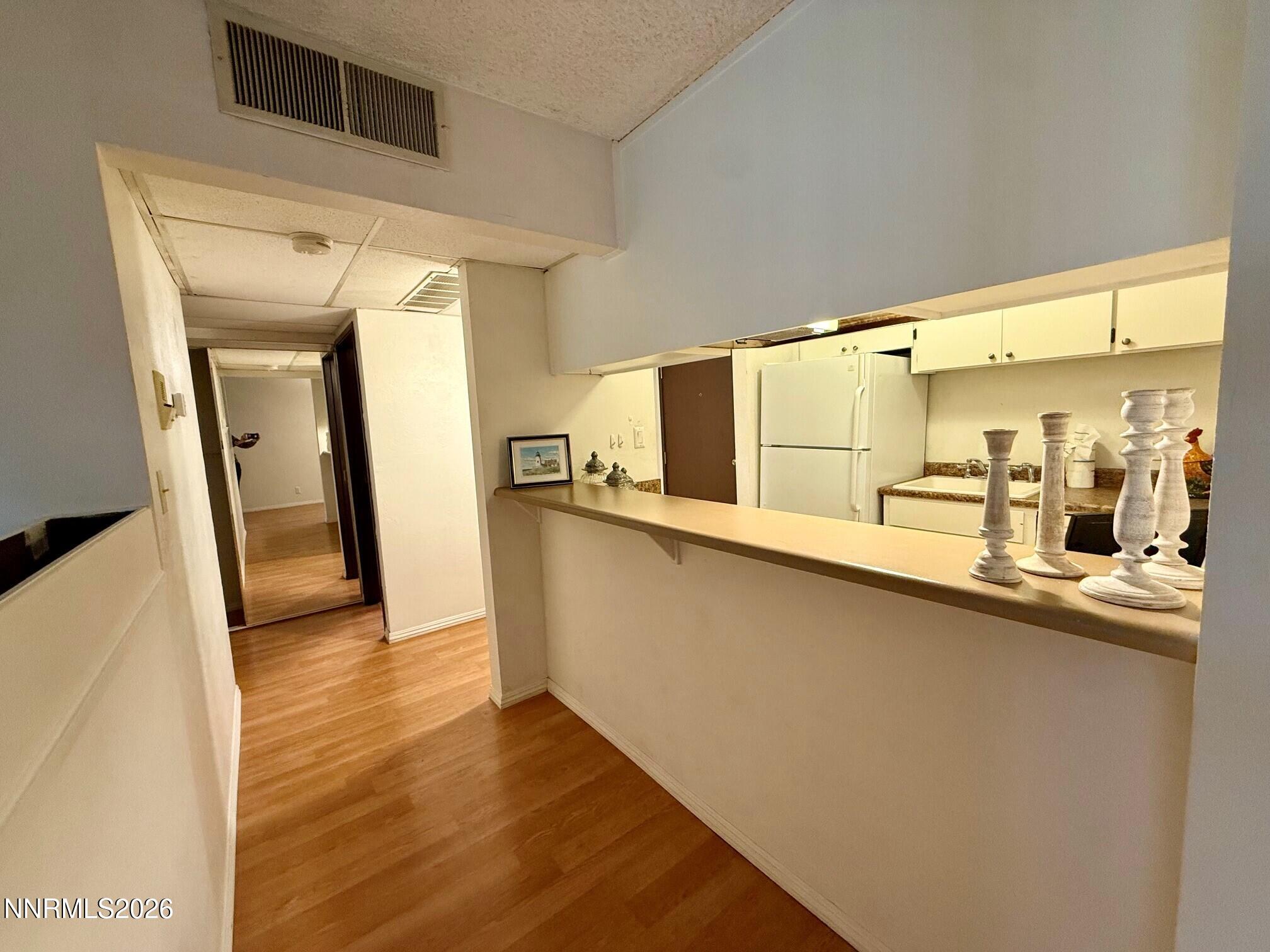 2955 Lakeside Drive, Unit 120 Reno, NV 89509 - Photo 7 of 21 a kitchen with stainless steel appliances a sink and a refrigerator