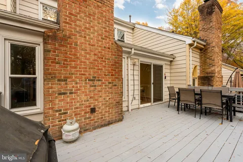 a view of a patio with table and chairs and wooden floor