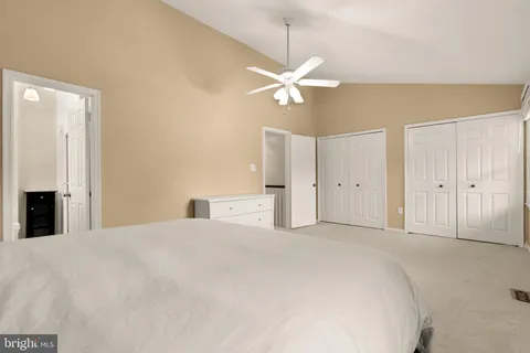 a bathroom with a granite countertop sink a toilet and a mirror