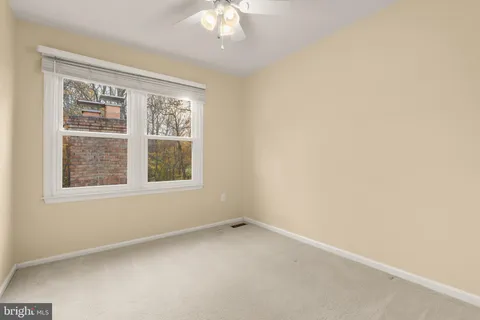 a view of an empty room with a fireplace