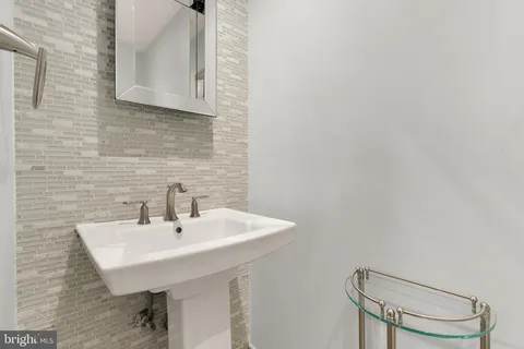 a bathroom with a sink a mirror and a toilet