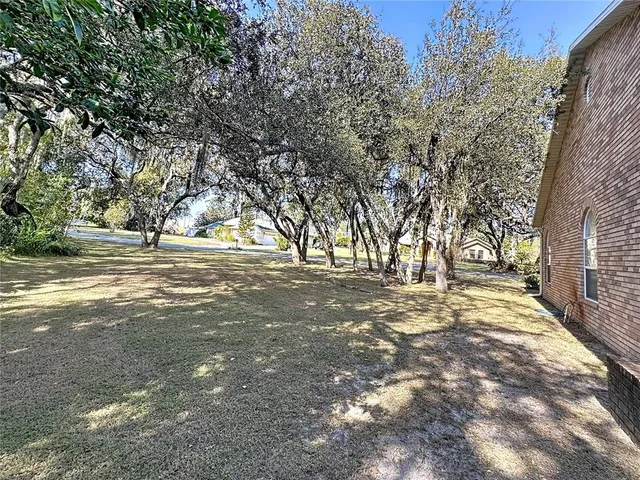 a living room with furniture and a view of kitchen