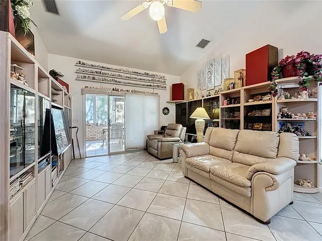a view of a workspace with furniture and a bookshelf