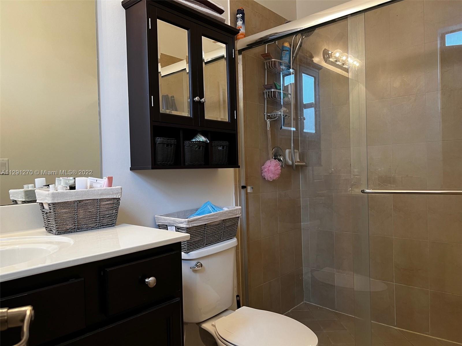 Oasis Homestead, FL 33033 - Photo 11 of 24 a bathroom with a sink toilet and shower