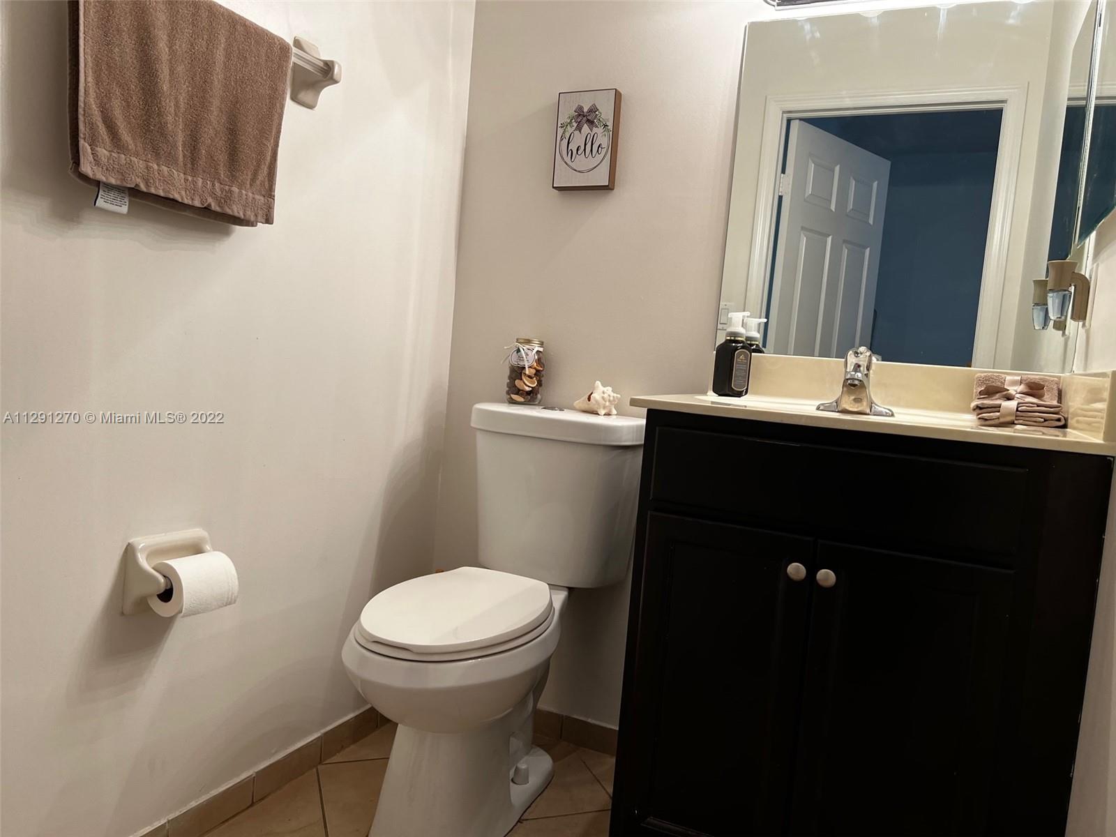 Oasis Homestead, FL 33033 - Photo 17 of 24 a bathroom with a sink a toilet and mirror