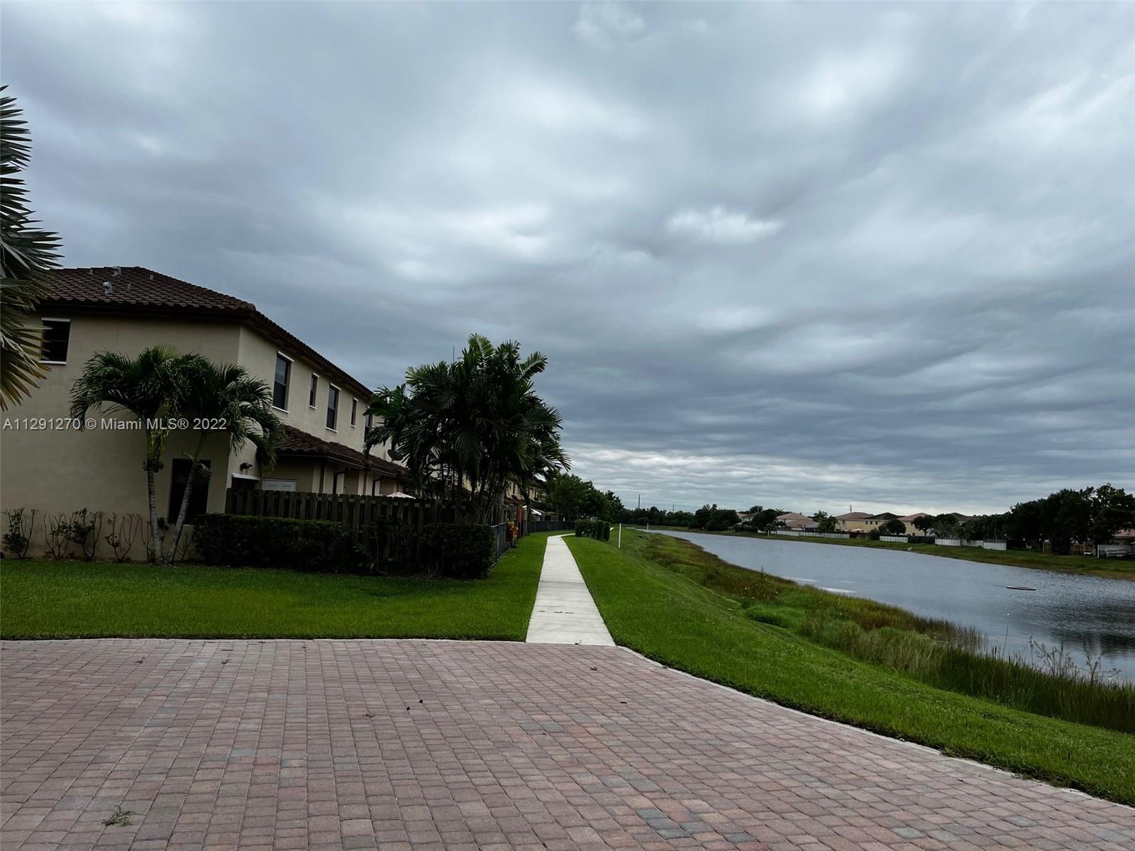 Oasis Homestead, FL 33033 - Photo 2 of 24 a view of a garden with tall buildings