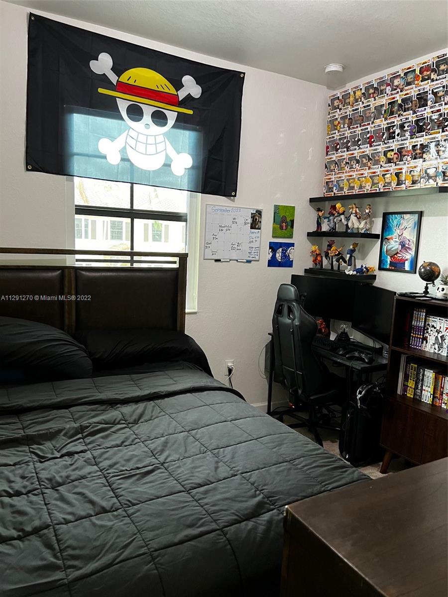 Oasis Homestead, FL 33033 - Photo 22 of 24 a bedroom with a bed and a television