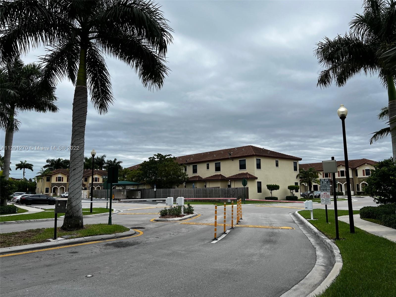 Oasis Homestead, FL 33033 - Photo 3 of 24 a swimming pool with outdoor seating and house in the background