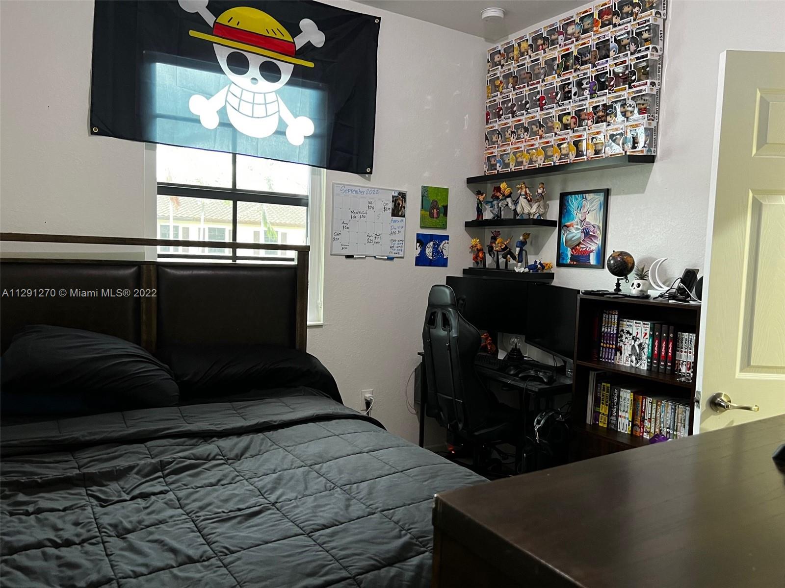 Oasis Homestead, FL 33033 - Photo 7 of 24 a bedroom with a bed and a book shelf