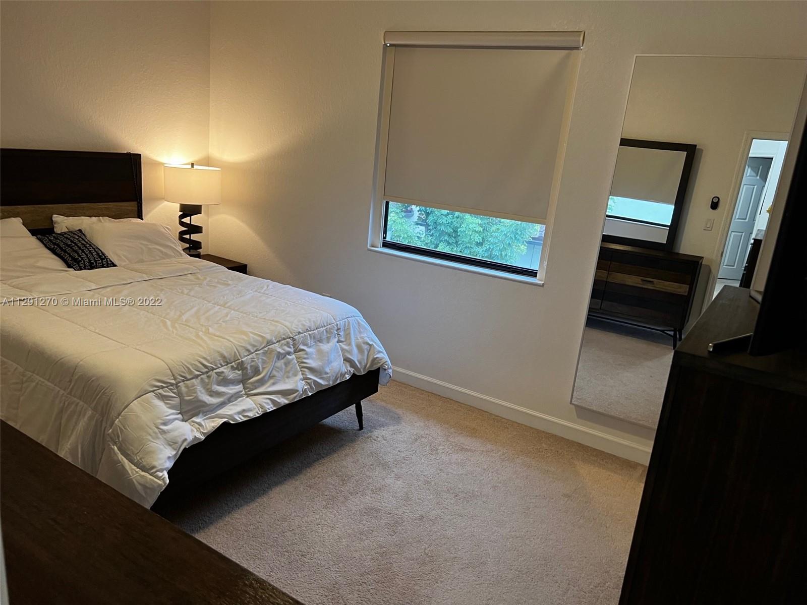 Oasis Homestead, FL 33033 - Photo 8 of 24 a bedroom with a bed and wooden floor