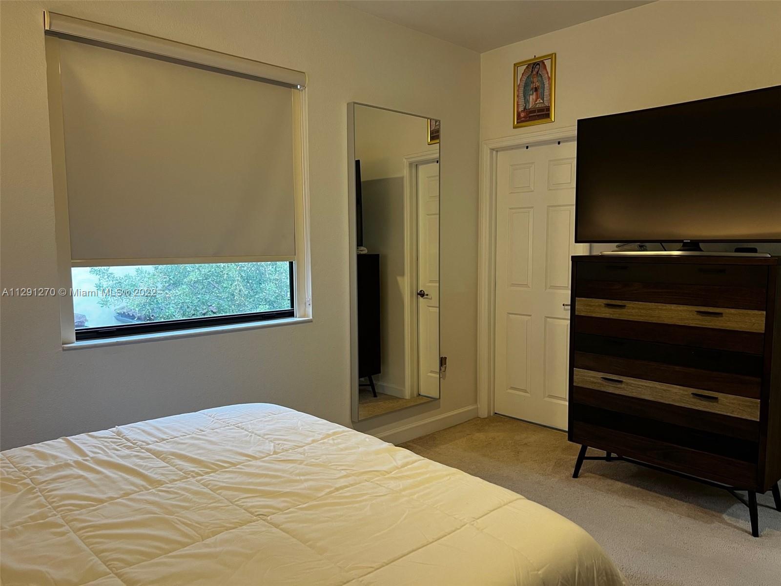 Oasis Homestead, FL 33033 - Photo 9 of 24 a bedroom with a bed and a flat screen tv