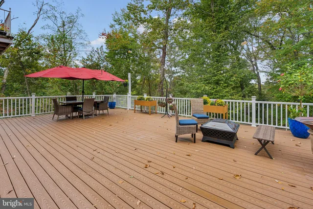 a view of a patio with a table and chairs under an umbrella