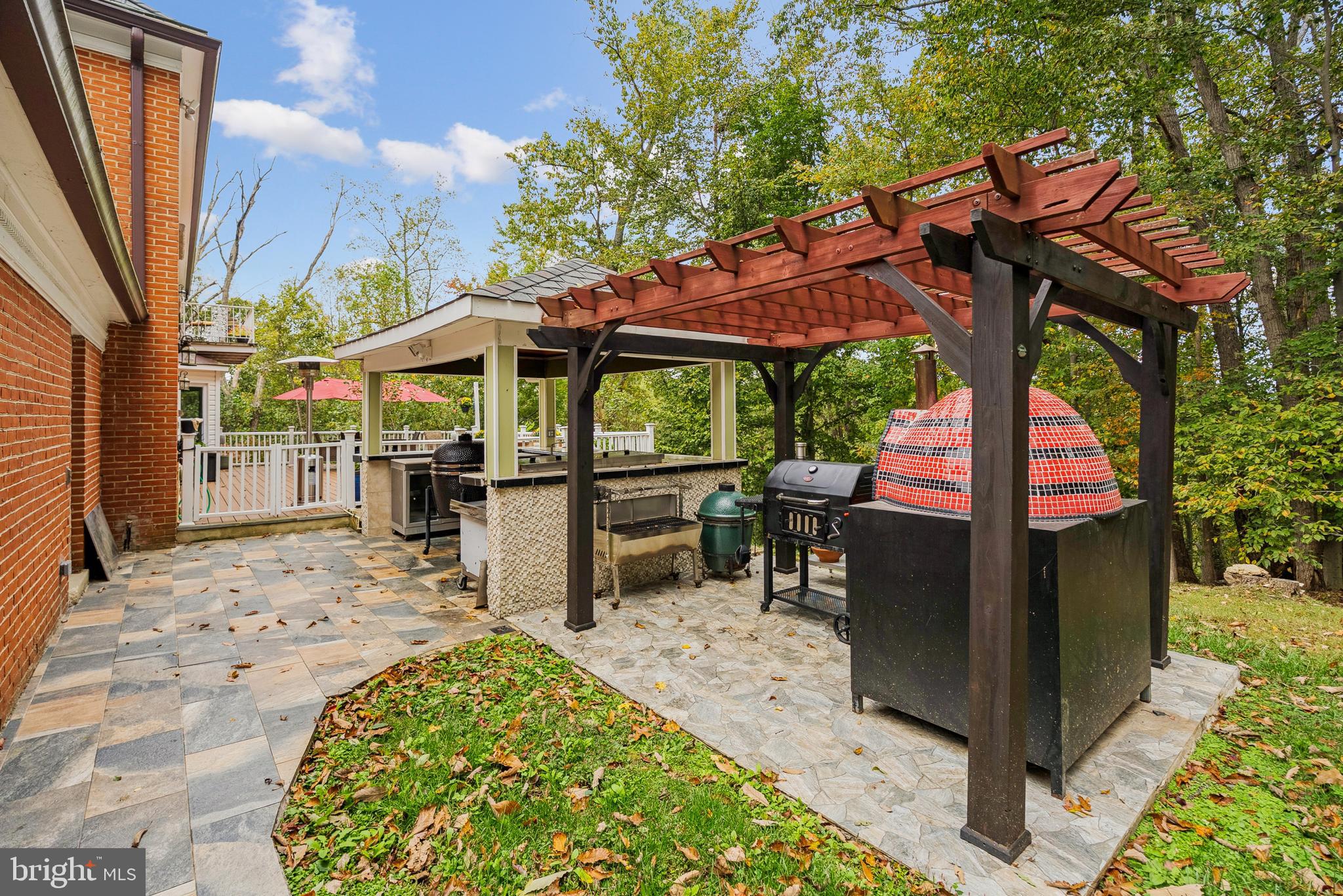 10900 Tara Road Potomac, MD 20854 - Photo 13 of 33 a view of a patio with a table and chairs under an umbrella