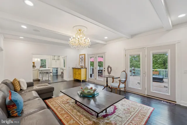 a bathroom with a granite countertop sink toilet a mirror and shower curtain
