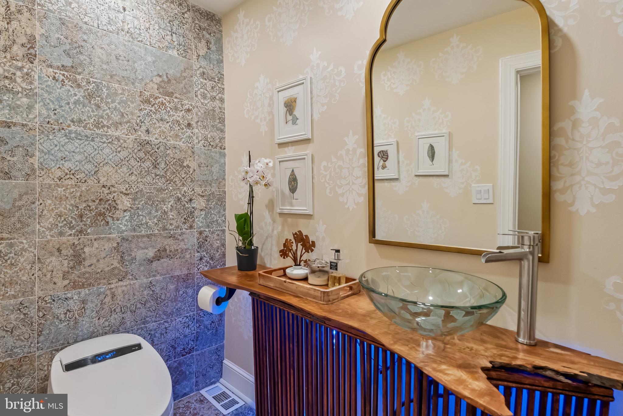 10900 Tara Road Potomac, MD 20854 - Photo 16 of 33 a bathroom with a granite countertop sink toilet a mirror and shower curtain
