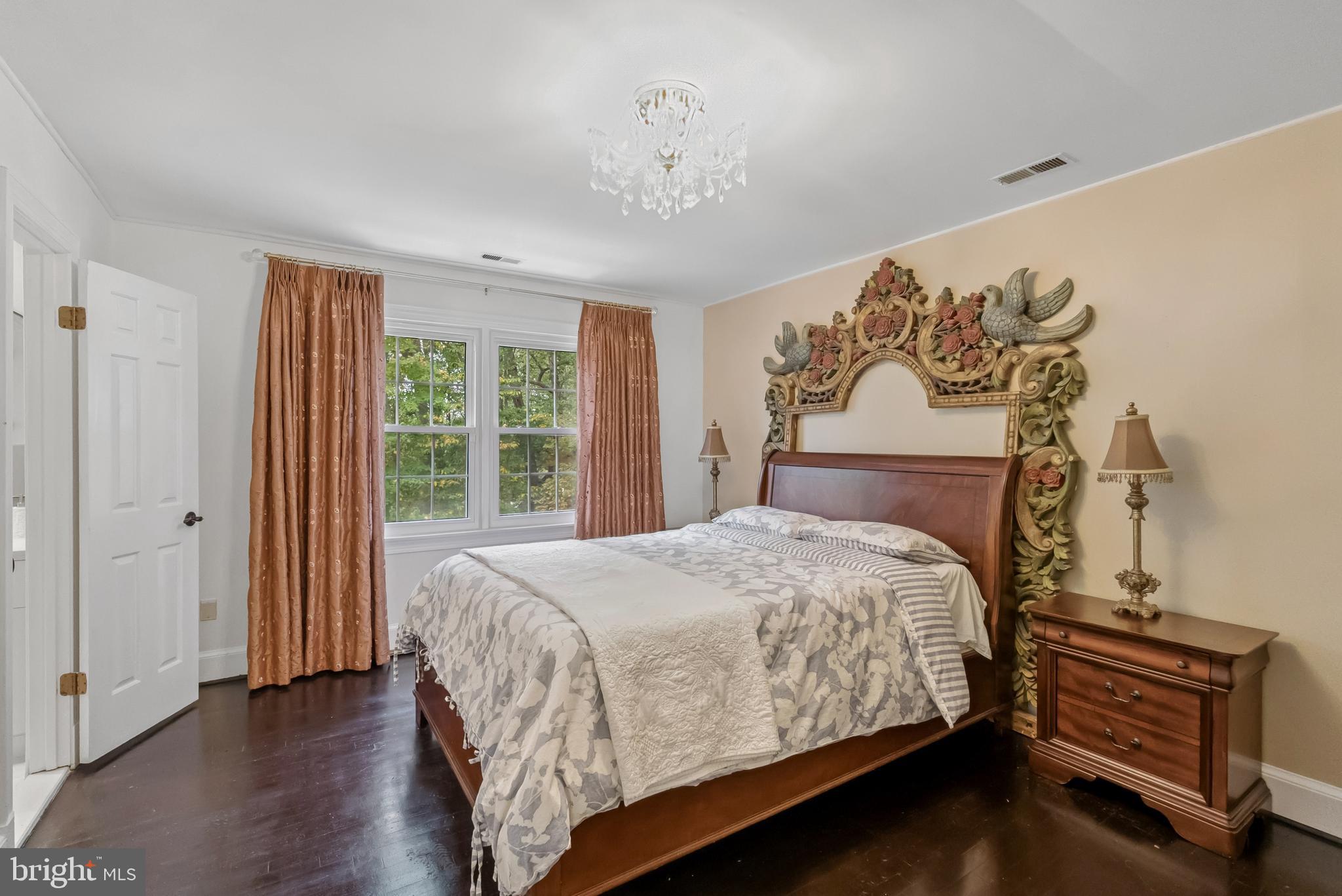 10900 Tara Road Potomac, MD 20854 - Photo 21 of 33 a bedroom with a bed and wooden floor