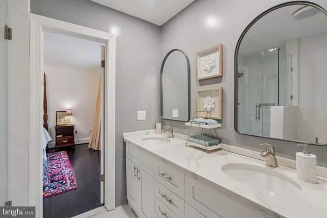 a bedroom with a bed and a dresser next to a window