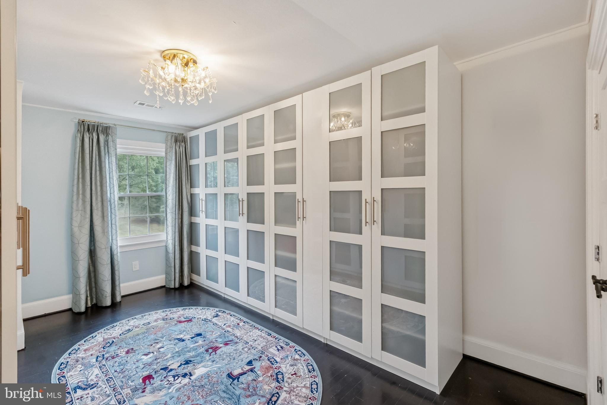10900 Tara Road Potomac, MD 20854 - Photo 24 of 33 a spacious bedroom with a bed and a chandelier