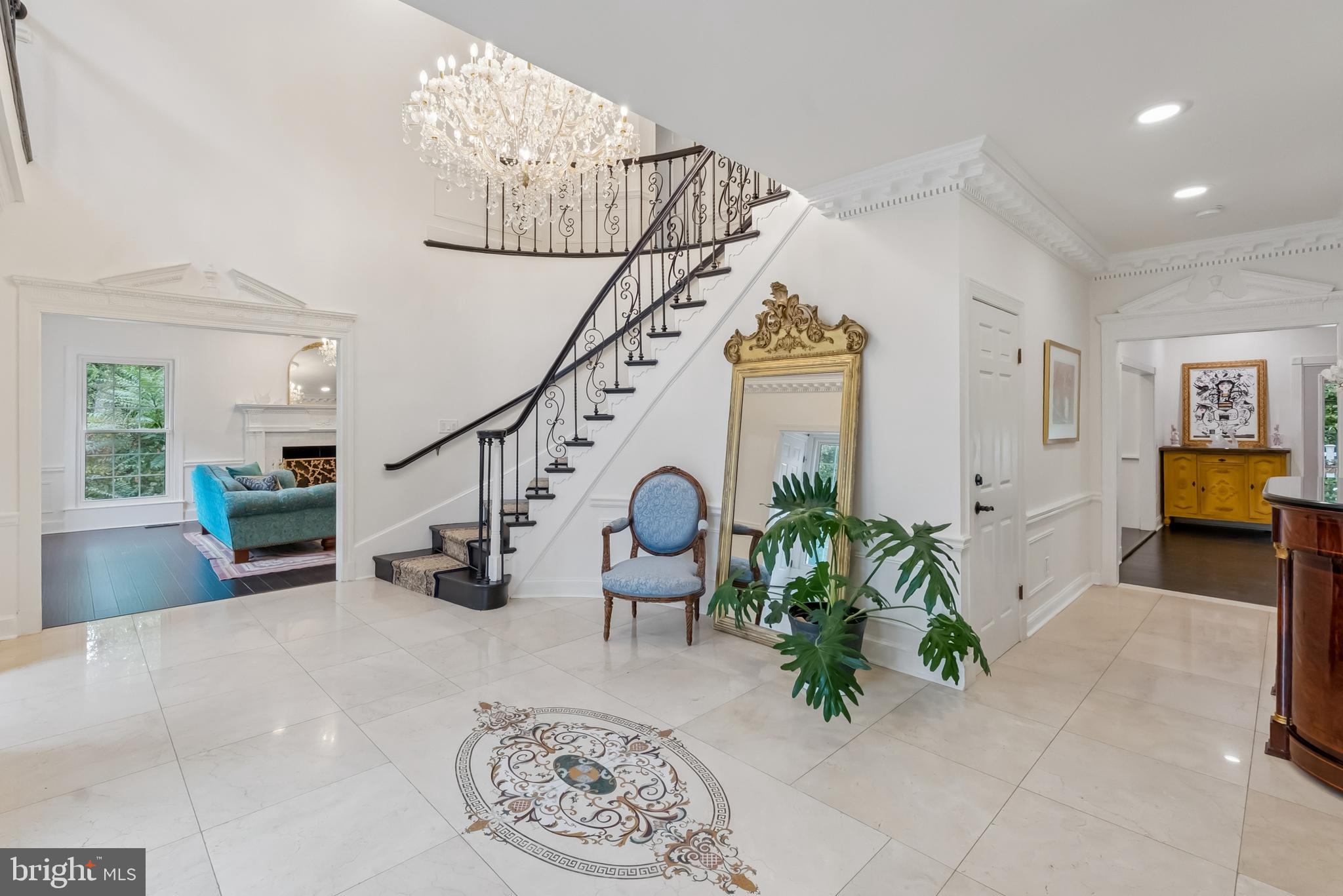 10900 Tara Road Potomac, MD 20854 - Photo 4 of 33 a living room with furniture flowers and a chandelier