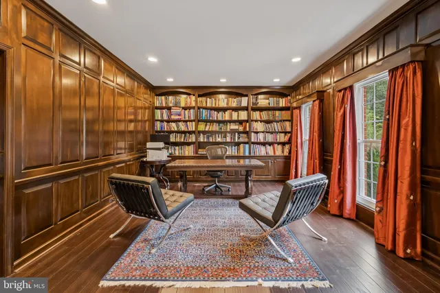 a living room with furniture chandelier and a fireplace