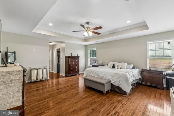 a spacious bedroom with a bed and a chandelier