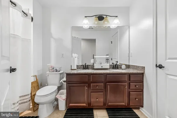 a bathroom with a toilet a sink and a mirror