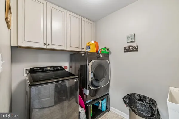 a kitchen with a stove a microwave a sink and cabinets