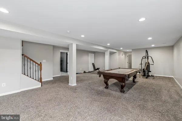 a living room with furniture pool table and a window