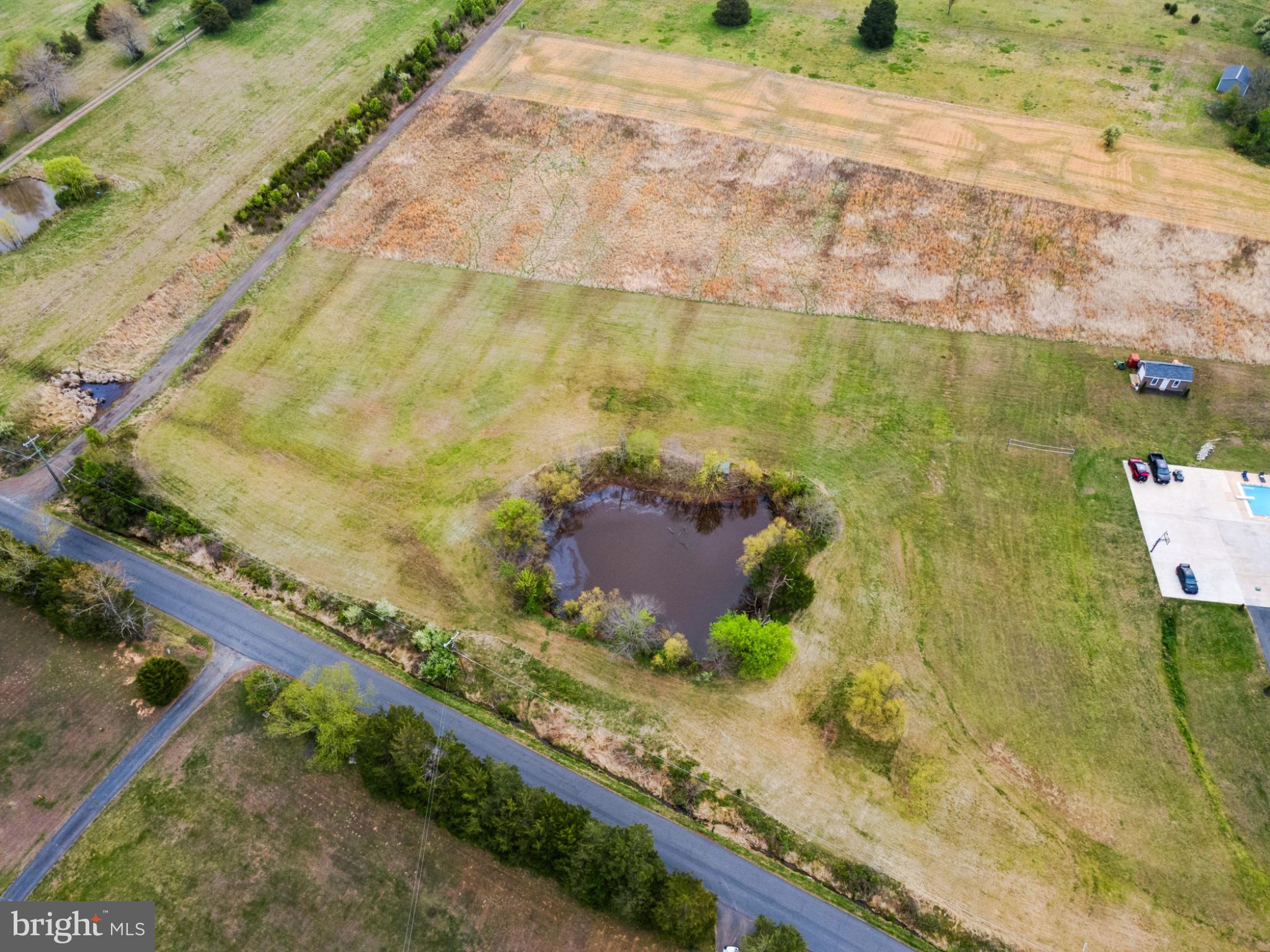 14081 Carriage Ford Road Nokesville, VA 20181 - Photo 35 of 40 Serene pond amidst open fields.