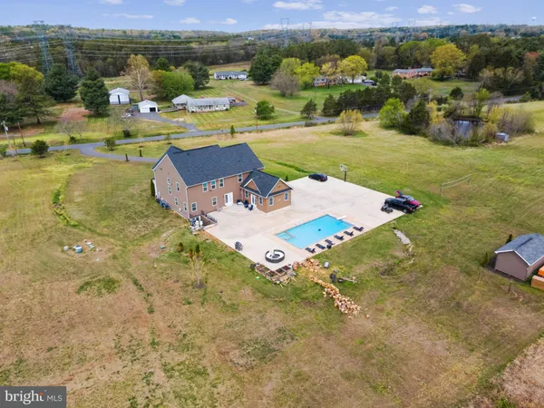 an aerial view of a house with garden space and lake view