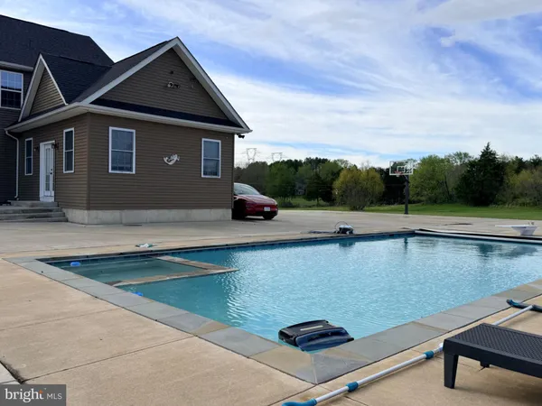 swimming pool view with a outdoor seating