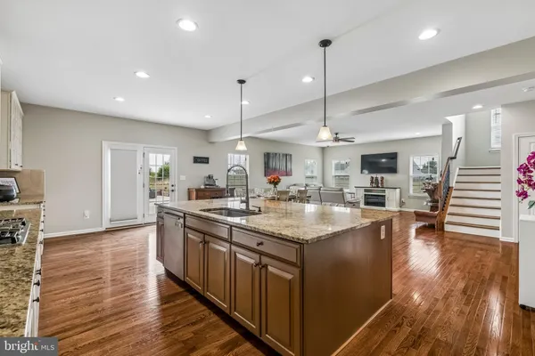 a kitchen with lots of counter top space and wooden floor