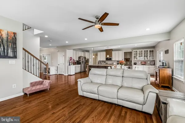 a living room with furniture and a view of kitchen