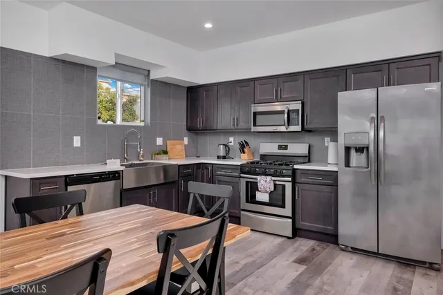 a kitchen with a stove a refrigerator and a stove top oven