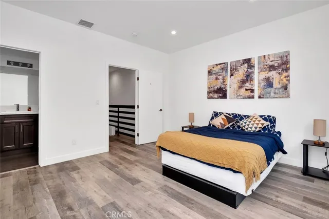 a bedroom with a bed and a view of kitchen