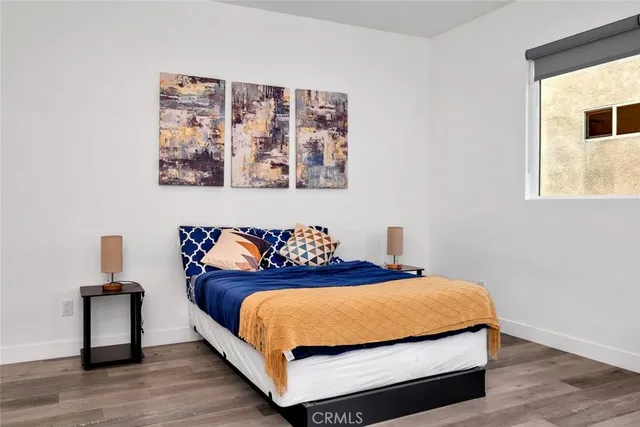 a bedroom with a bed and a night stand