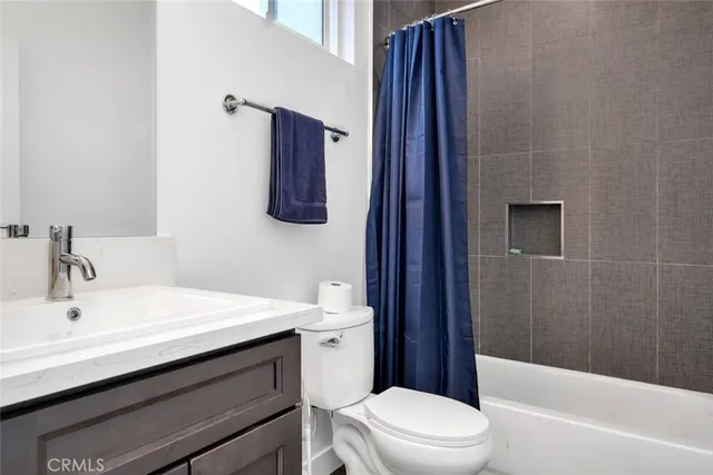 a bathroom with a sink a toilet a shower and a mirror