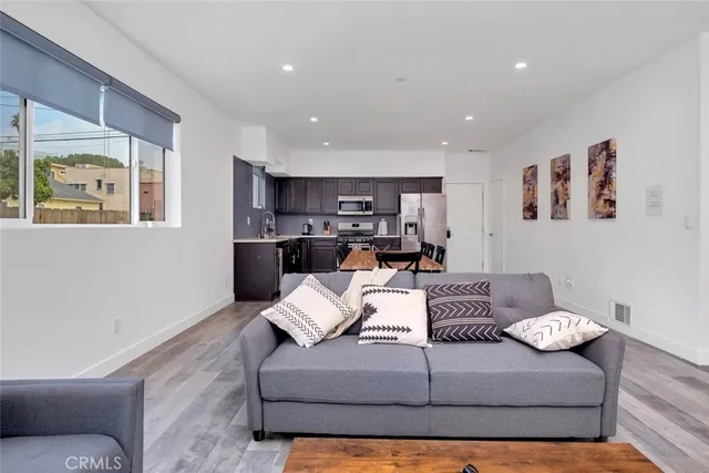 a living room with furniture or kitchen view and a window